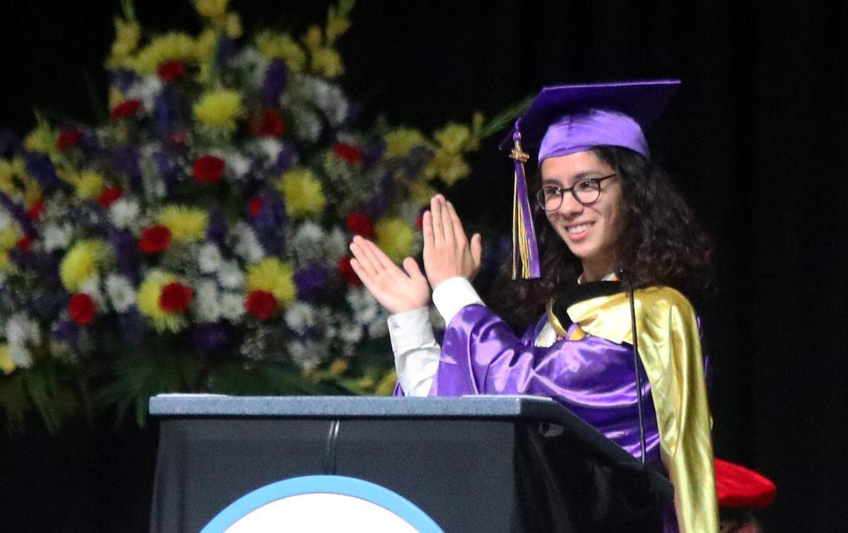 Fresno High valedictorian speaker Conor Youheir Hustedde applauds the graduates during the June 8, 2022 graduation ceremony at the Save Mart Center.