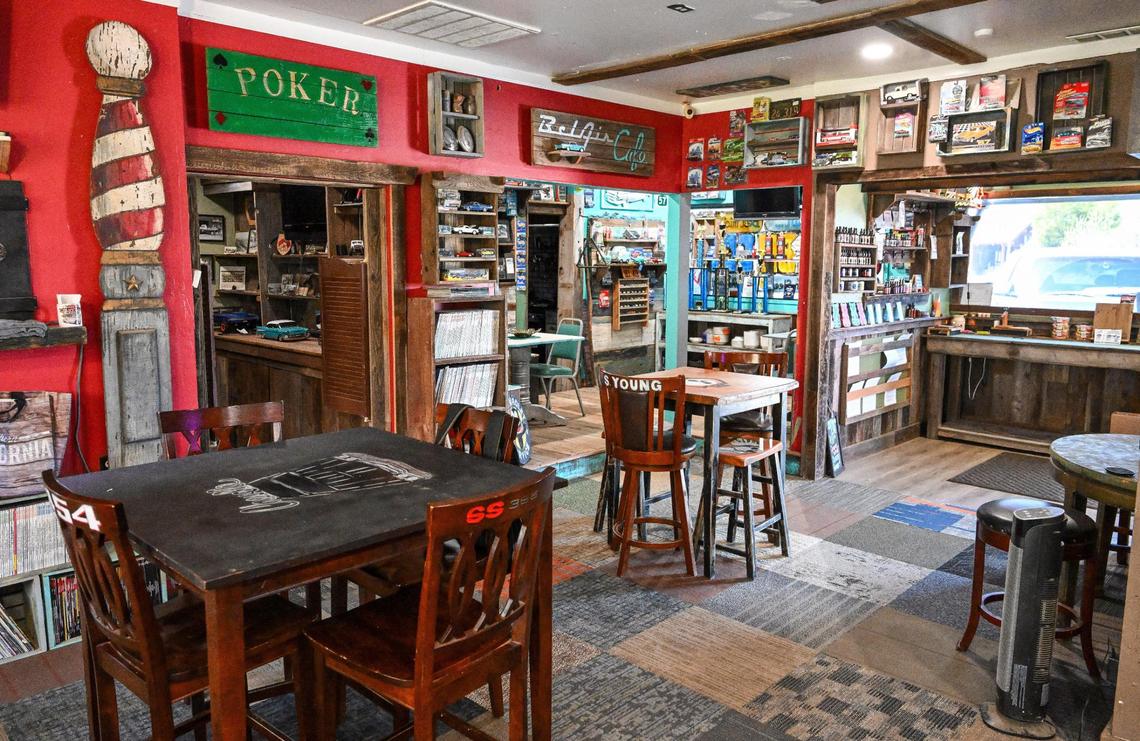 Tables surrounded by signs and other decorations sit inside the Yosemite Hemp Co., a CBD shop in Friant that also serves as an event space where you can find classic cars, crafted bird houses and barbecue.