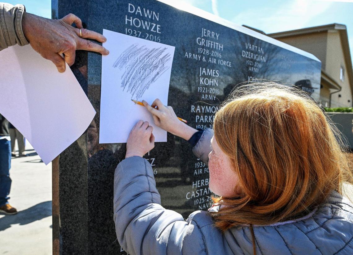 Alie Sundstrom, 8, of Clovis does a pencil rubbing of her great grandfather Gordon Caldis’s name etched in the wall of the Fresno Veterans Home Memorial Project which was unveiled to to honor those who called the facility their home at the Veterans Home of California in west Fresno on Monday, March 4, 2024.