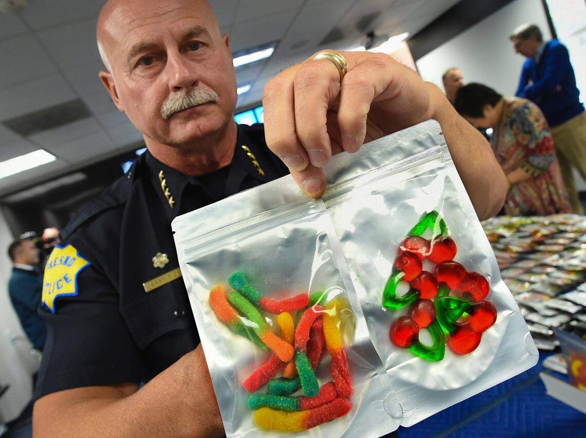 Fresno Police Chief Jerry Dyer holds gummy candies infused with cannabis part a 150-pound seizure of edibles from a Fresno marijuana dispensary on April 27, 2018. Dyer made the bust public May 2 in part "to send a message" to other dispensaries he told Bee columnist Marek Warszawski.