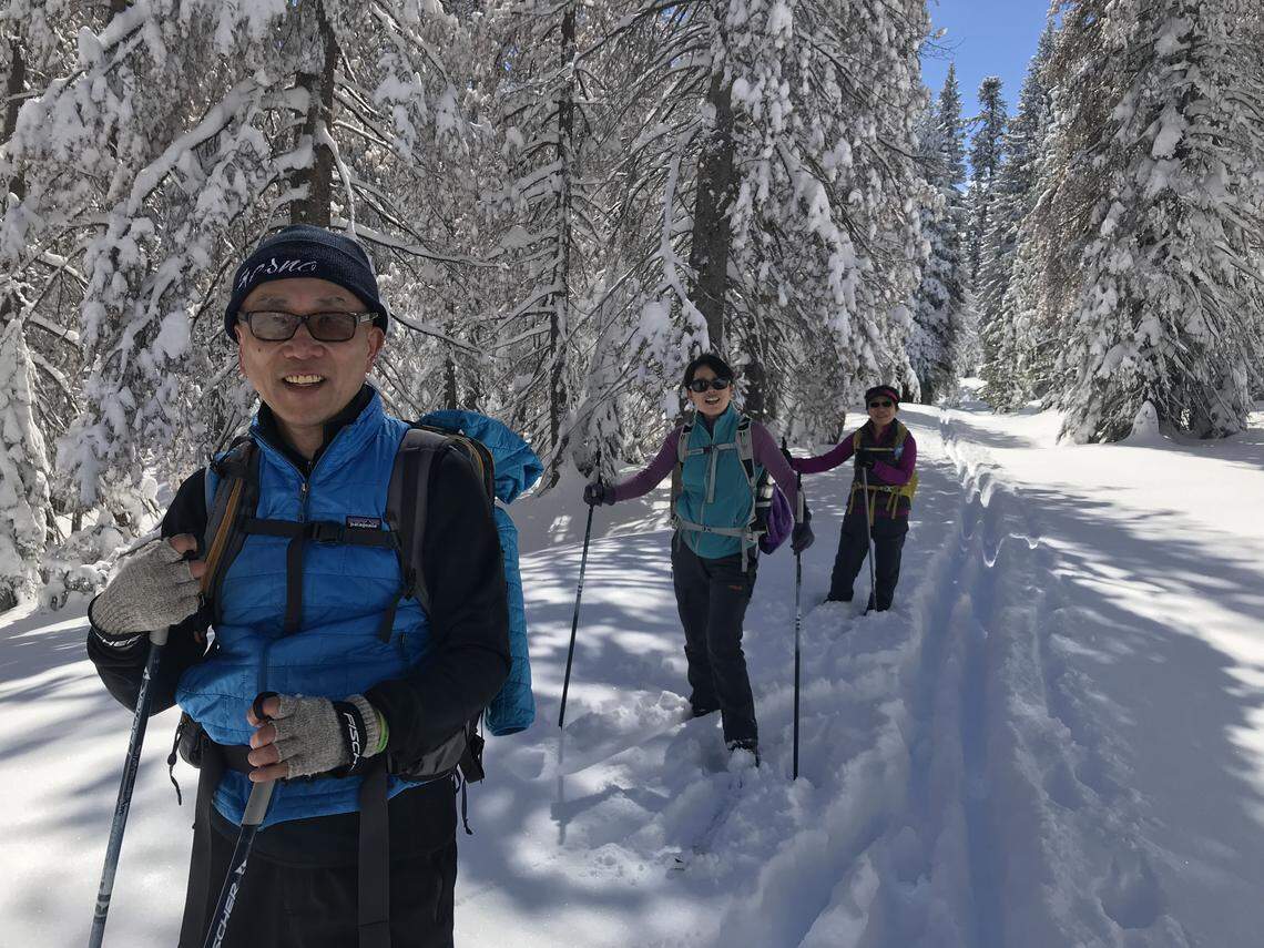 Fom left to right, James Yan, Qi Sun and Baorong Chen of Fresno enjoy the cross-country ski tracks that begin at the Coyote Sno-Park along Highway 168 east of Shaver Lake on Sunday, March 4, 2018.
