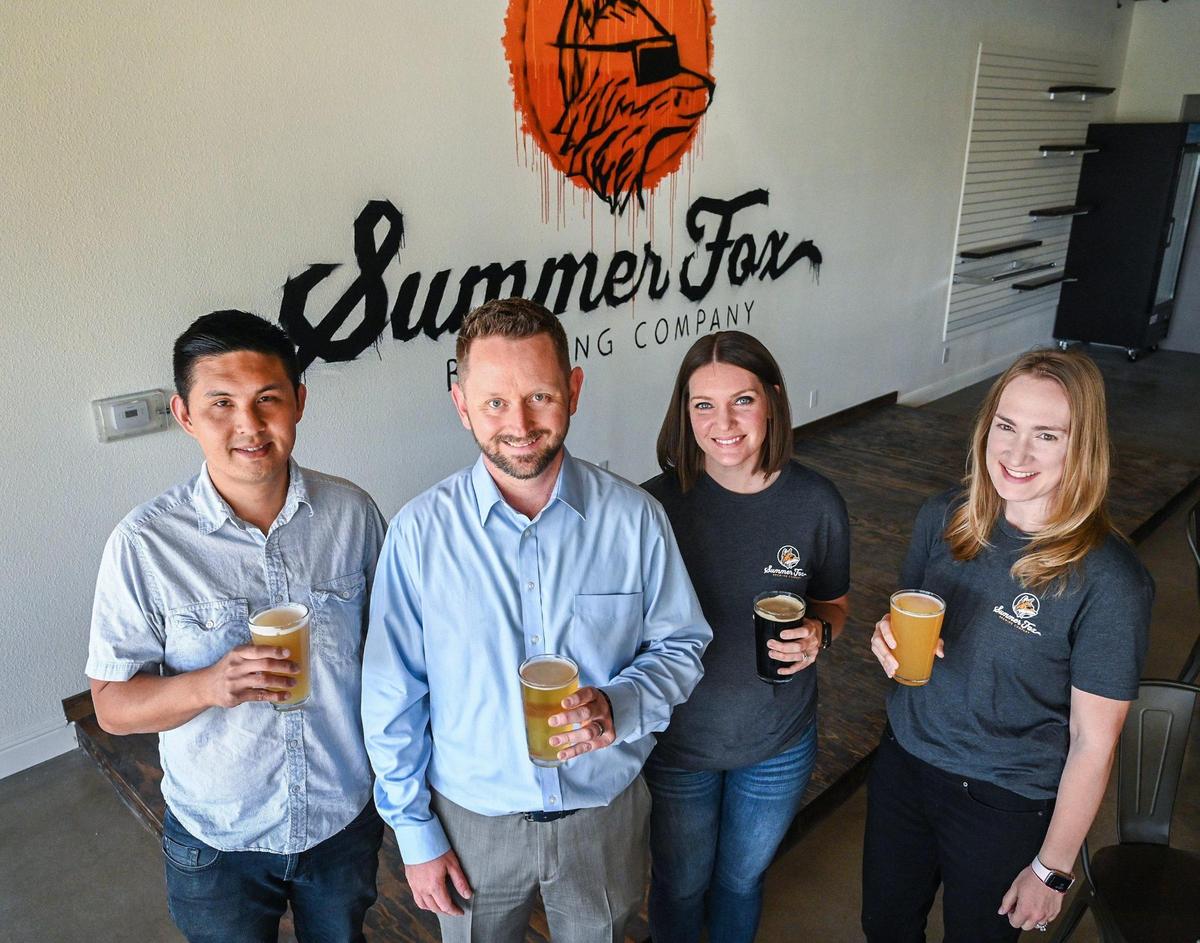 Owners of Summer Fox Brewing Company, from left, Gary Hsia, Kevin Lisitsin, Sarah Lisitsin and Bethany Hsia stand in their new location on Clovis Avenue in Clovis on Wednesday, April 6, 2022.