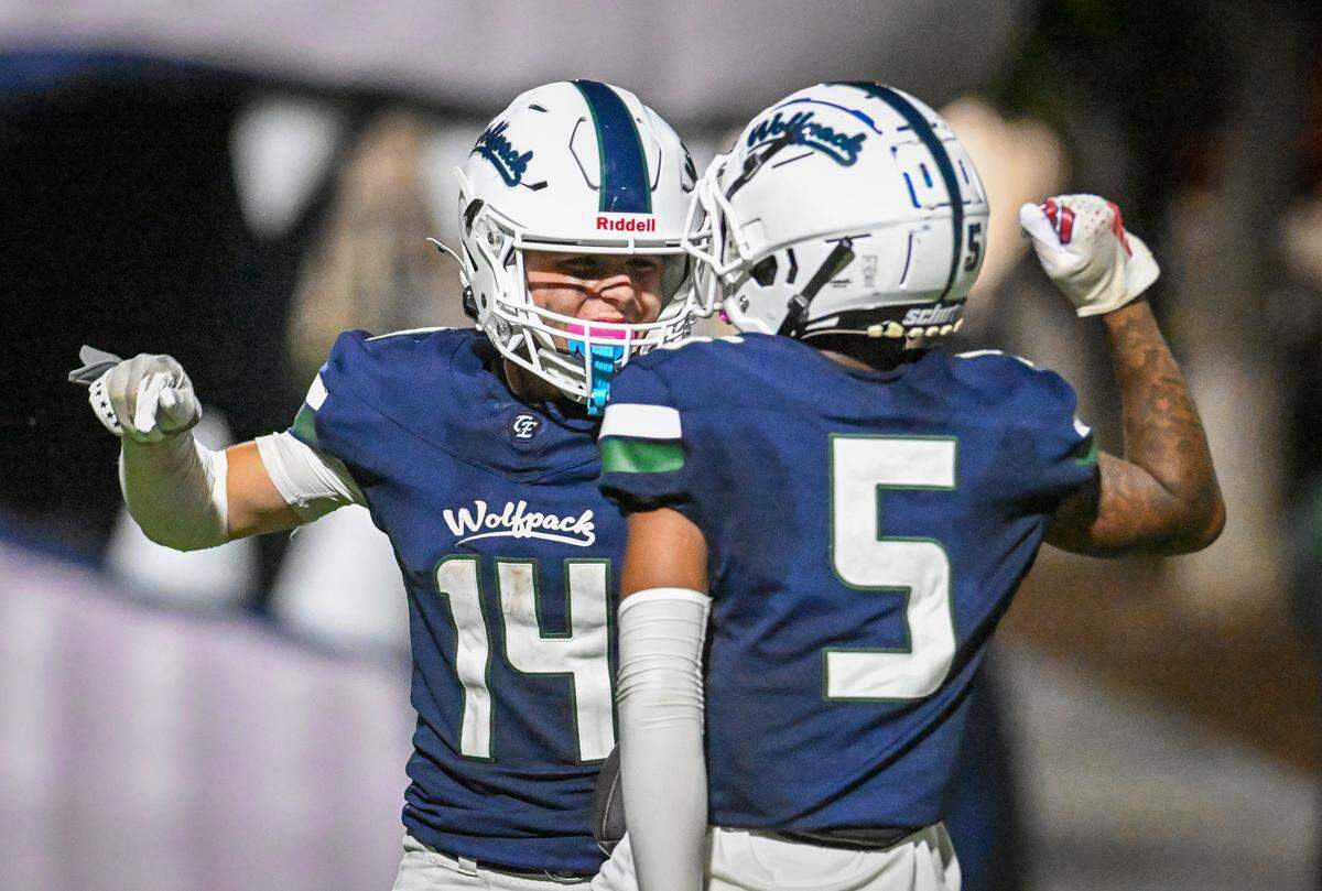 Clovis East wide receiver Elijah Wilson, left, celebrates with teammate LaBrent Harvey after catching a touchdown pass during their game against Sanger at Lamonica Stadium in Clovis on Friday, Sept. 5, 2025.