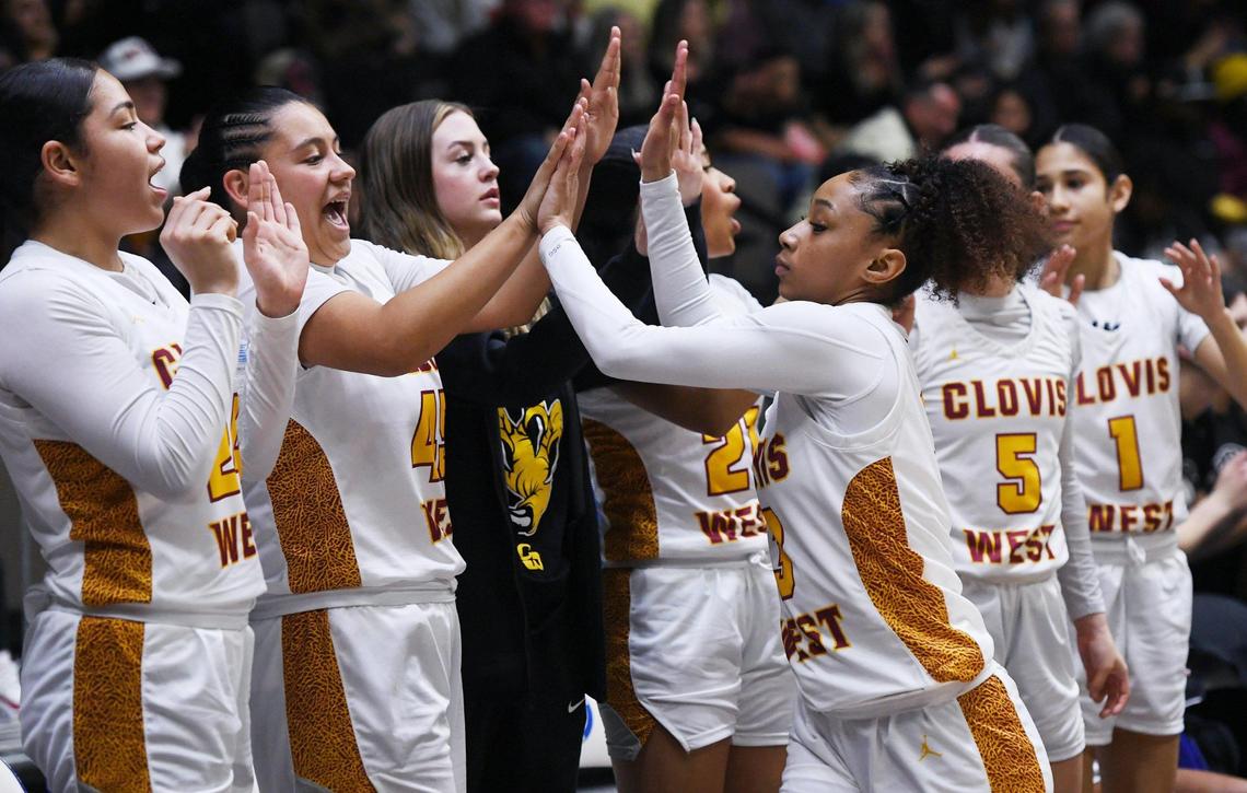 The Clovis West bench cheers a play against Clovis High in the Central Section girls Division I basketball championship Saturday, Feb. 25, 2023 in Fresno.