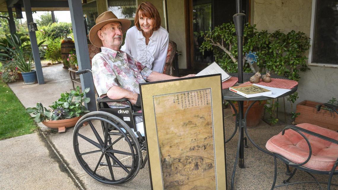 Pat Patterson of Clovis and his wife Kris stand with a copy of a painting he purchased in 2002 at a Fresno estate sale, on Tuesday, Oct. 21, 2020. The original painting turned out to be a rare piece by famous Korean artists which Patterson eventually had returned to the Korean people.