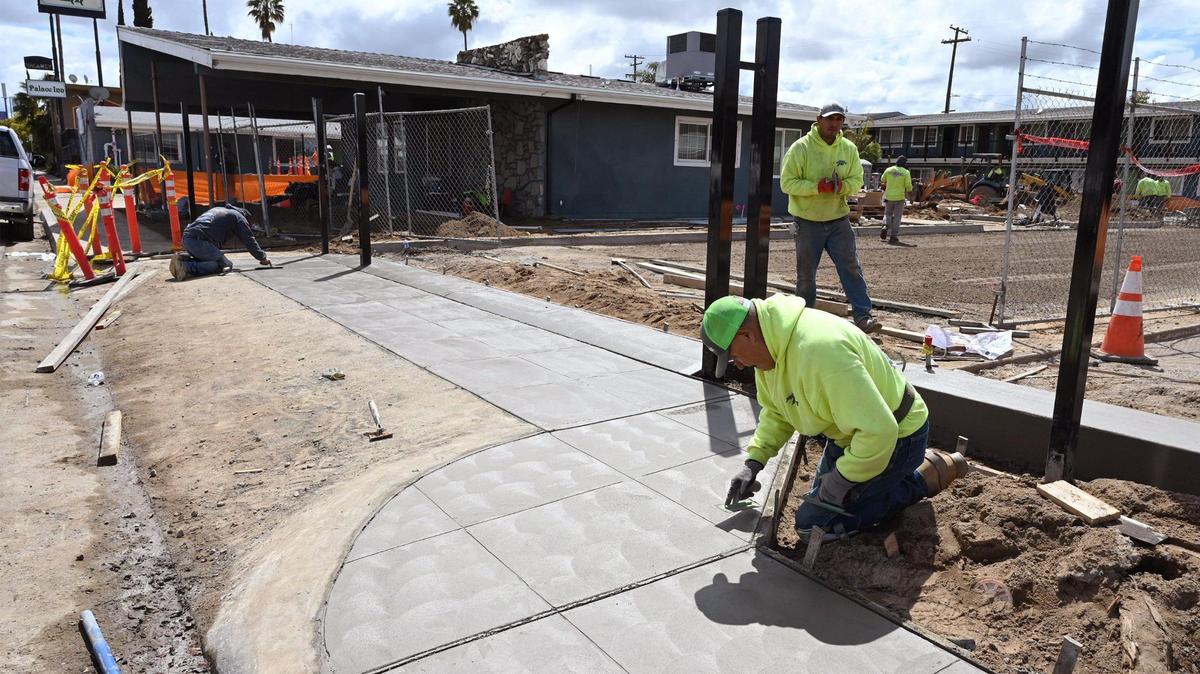 Workers renovate the city-owned west Fresno Villa Motel along Parkway Drive on March 30, 2023. The city of Fresno seeks more state funding to convert motels into affordable housing projects in central and northeast Fresno.