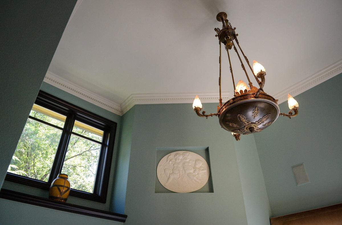 An ornate lighting fixture and cherub medallion inset in a wall are featured in the master bathroom of a European-style estate built in 1993 by Erna Kubin-Clanin, the former owner of Erna's Elderberry House, and her husband René Clanin.