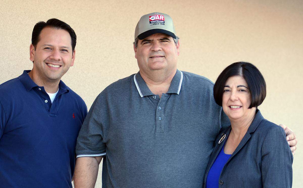 Karen Musson, right, with Greg Musson, center, and son-in-law Ralph Rendon at Gar Tootelian Inc. in Reedley in October 2013.