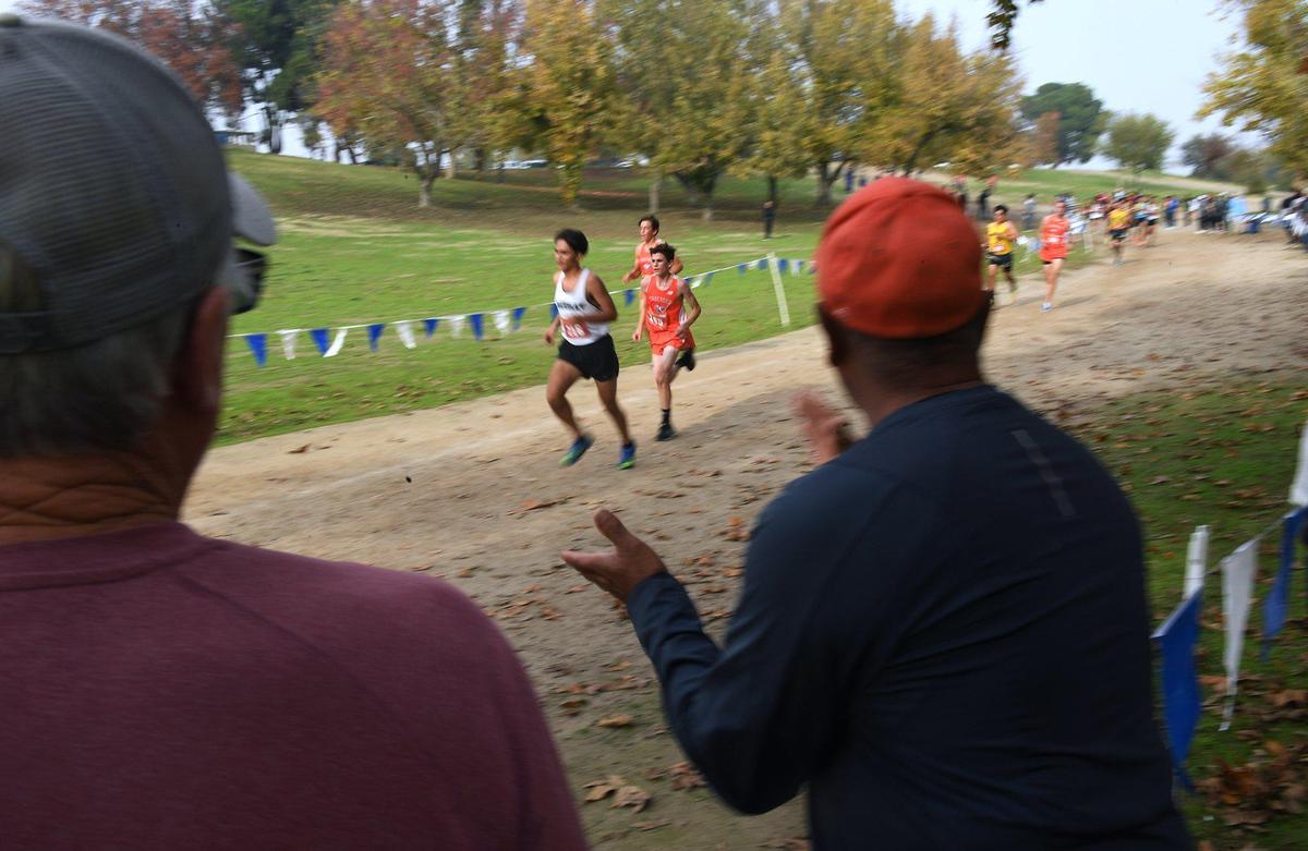 Fans cheer the runners at the Central Section cross country chamionships held at Woodward Park Thursday, Nov. 18, 2021 in Fresno.