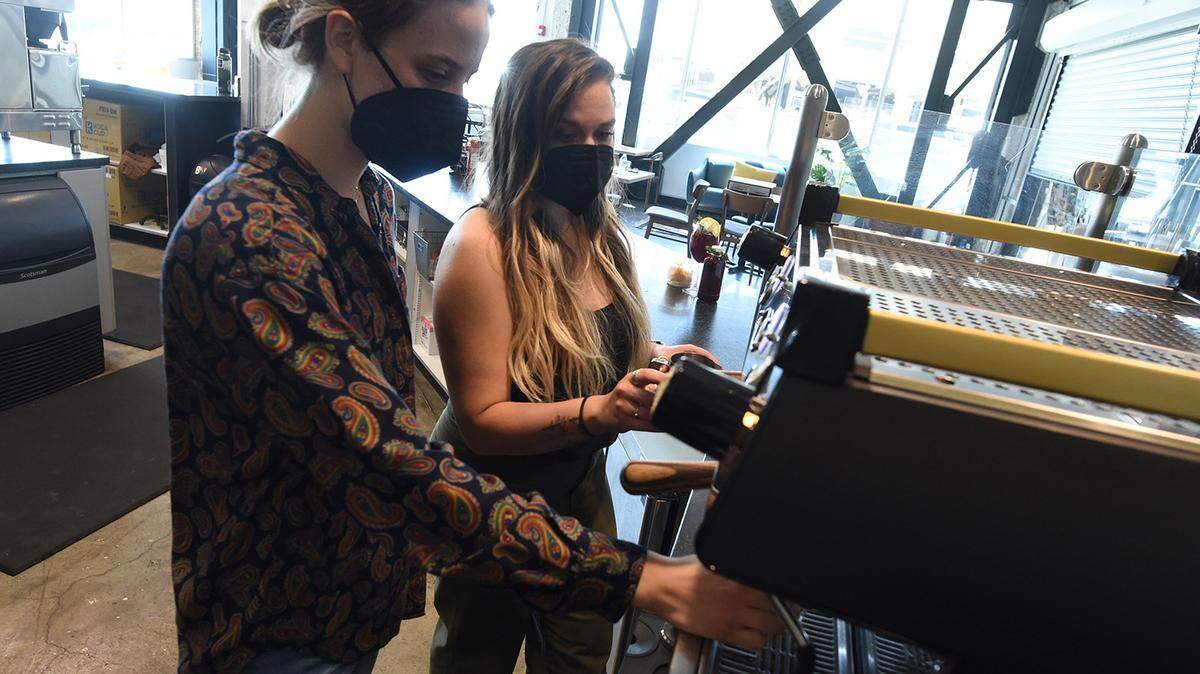 Cameron Evaro, left, and Amanda Ardemagni, prepare coffee drinks in the new cafe, ContemPLATE, at Bitwises South Stadium location in downtown.