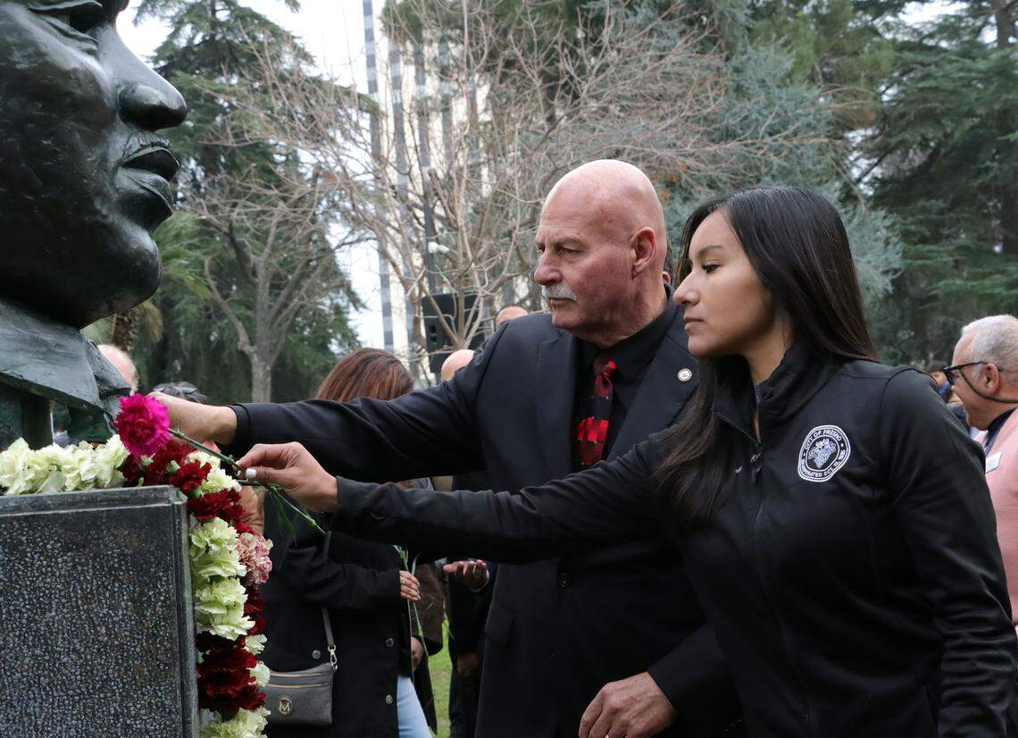 Fresno City Council President Annalisa Perea and Fresno Mayor Jerry Dyer place carnations on the bronze bust of Martin Luther King Jr. during garlanding ceremony Jan. 12 at Courthouse Park.