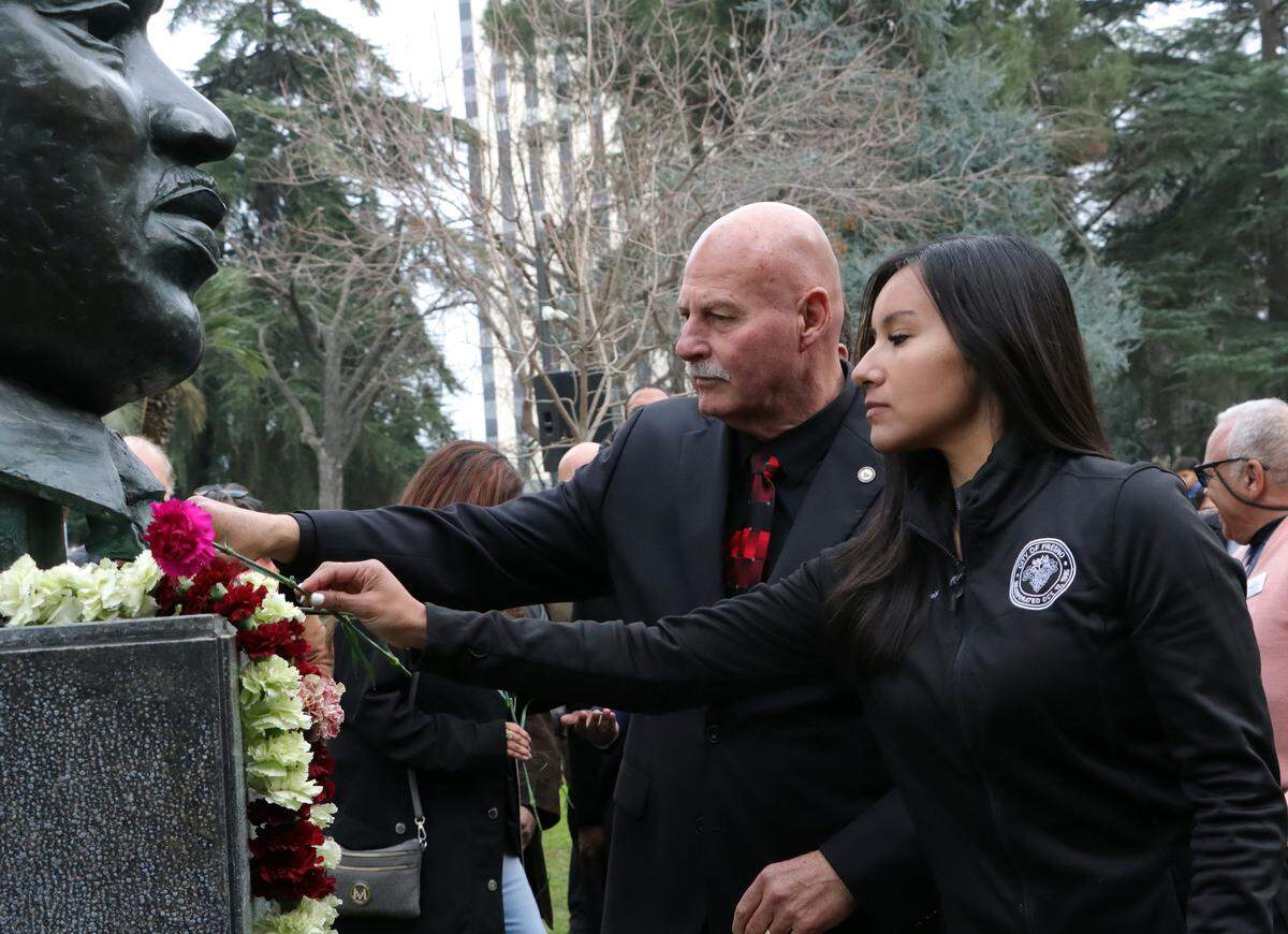 Fresno City Council President Annalisa Perea and Fresno Mayor Jerry Dyer place carnations on the bronze bust of Martin Luther King Jr. during garlanding ceremony Jan. 12 at Courthouse Park.