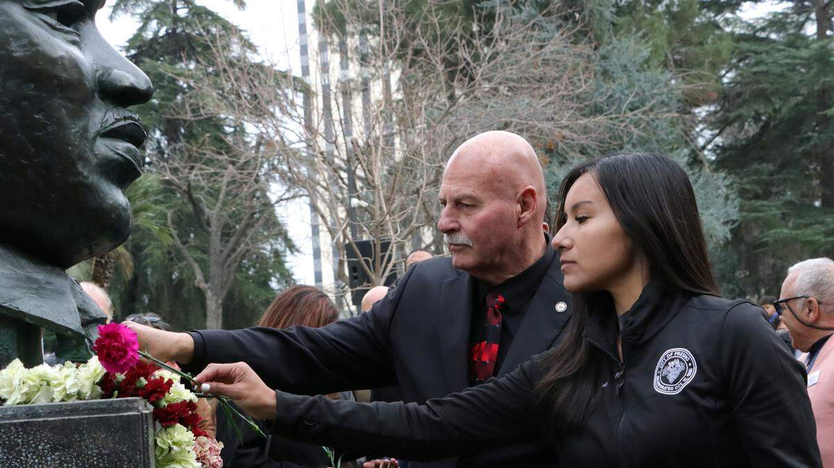 Fresno City Council President Annalisa Perea and Fresno Mayor Jerry Dyer place carnations on the bronze bust of Martin Luther King Jr. during garlanding ceremony Jan. 12 at Courthouse Park.