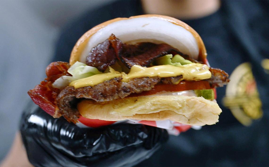 A smashburger is made for customers on Sizzlin Smash Burgers grand opening Friday, July 18, 2025 in Madera. The smashburger place is the first of its kind in Madera.
