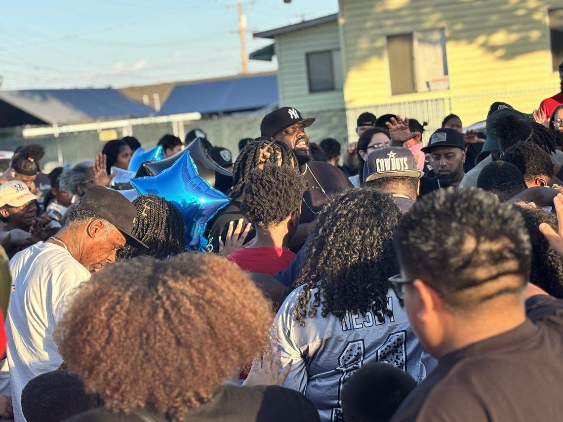 Pastor DJ Criner leads a prayer for Corday Brown, who died when a vehicle struck him on Sunday, Sept. 21, 2025.