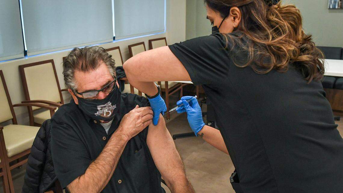 Stevon Combs of Fresno has his first dose of the Moderna COVID-19 vaccine administred by medical assistant Julia Valdez at WelbeHealth in Fresno on Thursday, Jan. 21, 2021.
