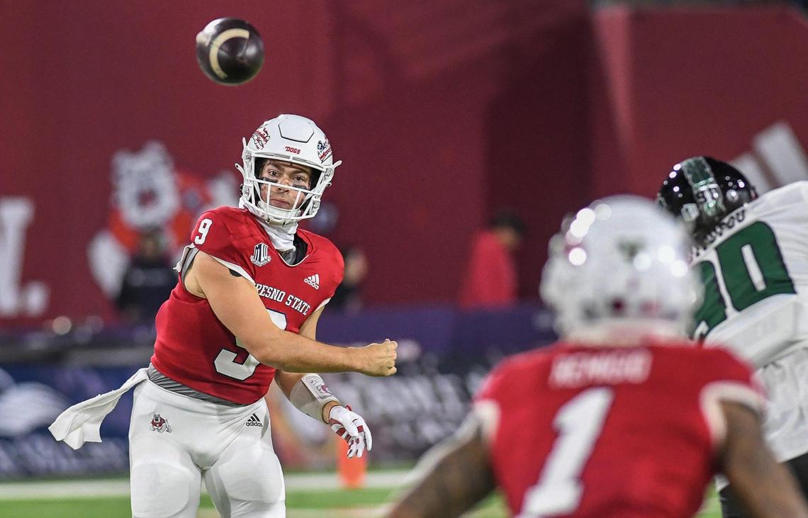Fresno State quarterback Jake Haener throws to receiver Nikko Remigio in the first half of their game against Hawaii at Valley Children’s Stadium on Saturday, Nov. 5, 2022.
