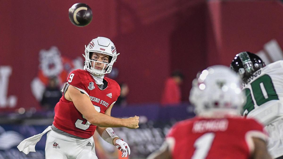 Fresno State quarterback Jake Haener throws to receiver Nikko Remigio in the first half of their game against Hawaii at Valley Children’s Stadium on Saturday, Nov. 5, 2022.