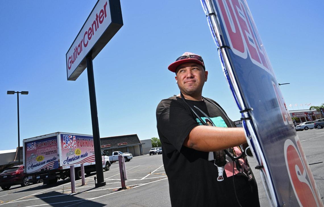 Gabriel Carpio works along Blackstone Ave. helping advertise for USA Furniture by standing on the sidewalk twisting a sign left and right all day along. Photographed Wednesday, May 29, 2024 in Fresno.