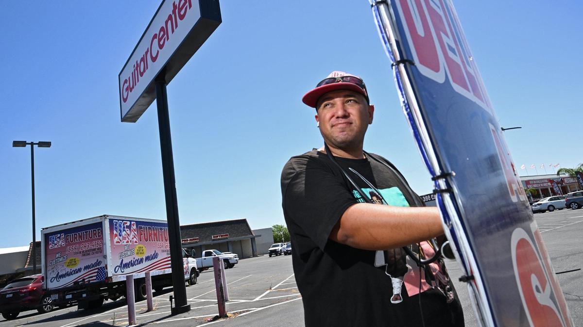 Gabriel Carpio works along Blackstone Ave. helping advertise for USA Furniture by standing on the sidewalk twisting a sign left and right all day along. Photographed Wednesday, May 29, 2024 in Fresno.