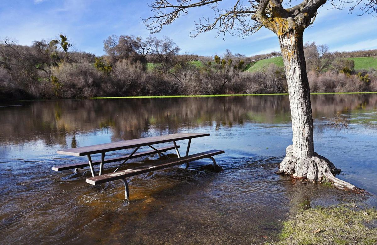 A picnic table at Lost Lake county park is inaccessible as water flows from Friant Dam increase Friday, Jan. 6, 2023 near Friant.