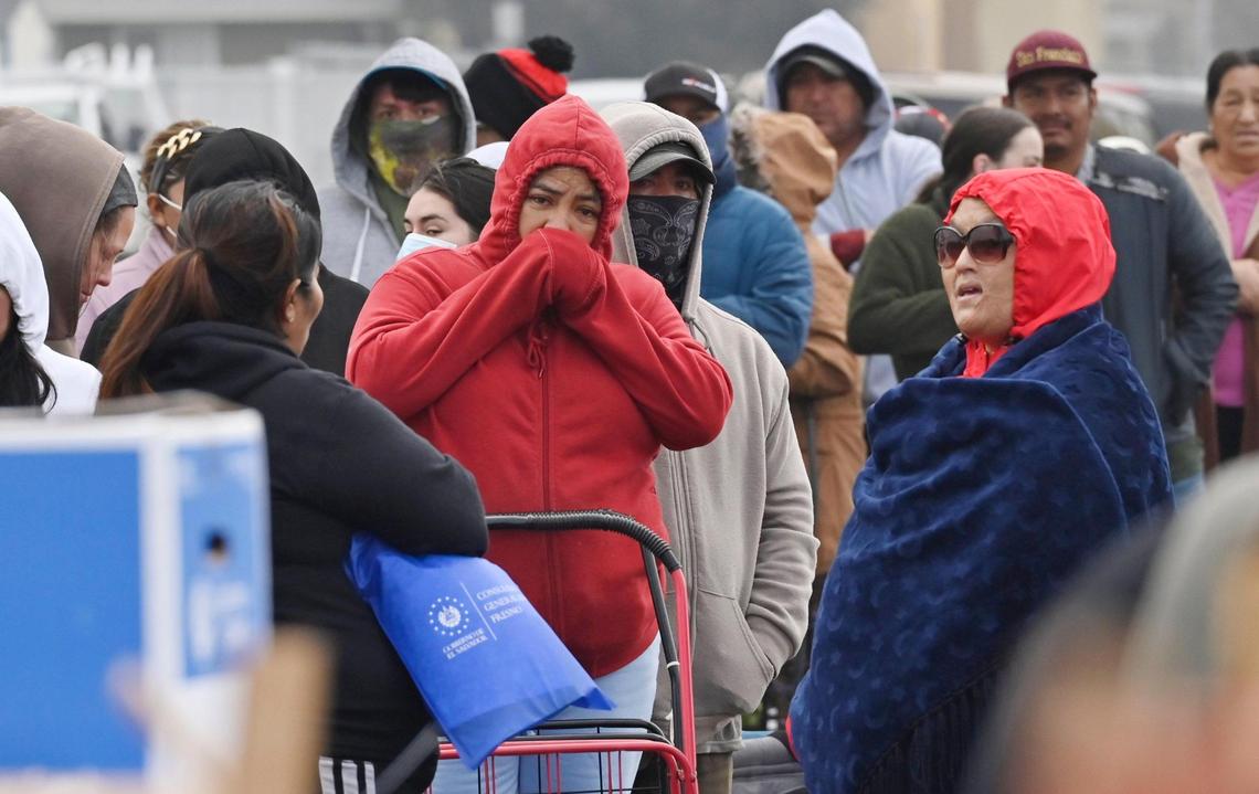 Community members line up for food bank handouts during a Covered California event held in Mendota Thursday morning, Dec. 12, 2024.