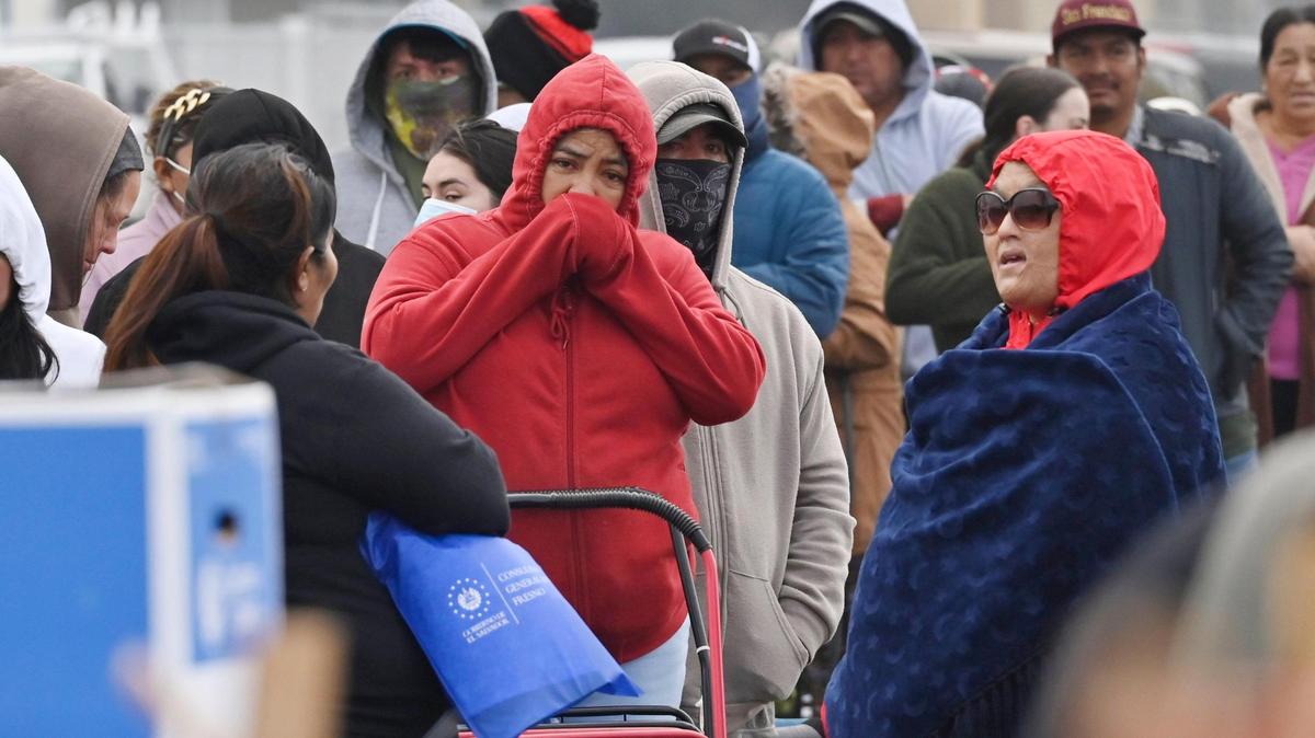 Community members line up for a food distribution event in Mendota Thursday morning, Dec. 12, 2024.
