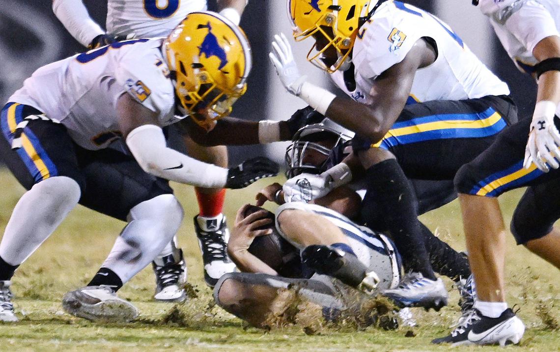 Clovis East quarterback slides to the ground on a keeper against Sacramento’s Grant Union in a game Friday, Sept. 13, 2024 in Clovis.