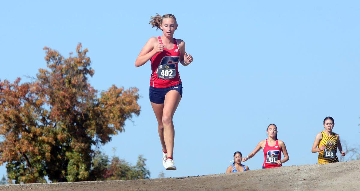 Sanger High sophomore Kinsley Allan (3rd, 19:37.5) competed in the CMAC cross country championships at Woodward Park on Nov. 8, 2023.