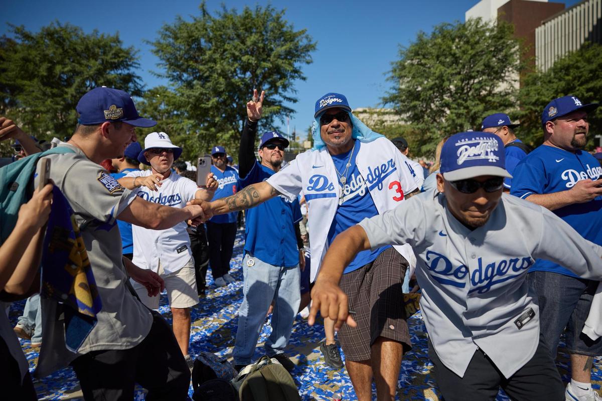 Fans dance as the Los Angeles Dodgers celebrate their World Series victory with a parade in Los Angeles, California, USA, 01 November 2024.