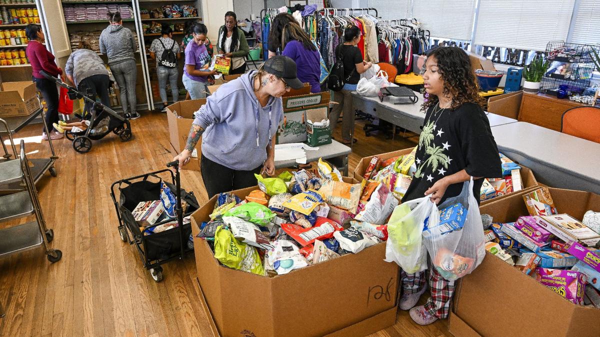 Naila Sightler, right, a Fort Miller Middle School seventh grade transfer student, and her mother, Amanda Hober, pack up food during the School’s Community School Food Pantry & Clothing Closet event at the Fresno school on Friday, March 8, 2024.