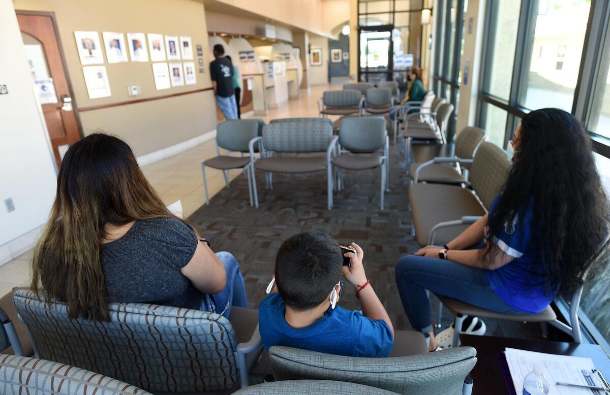 Clients wait in the lobby of Mendota’s United Health Center, April 28, 2021, which provides important services to the westside city’s population. Looming state changes, that would put health centers across the state, especially those in rural communities in the Central Valley, such as this one, at risk.