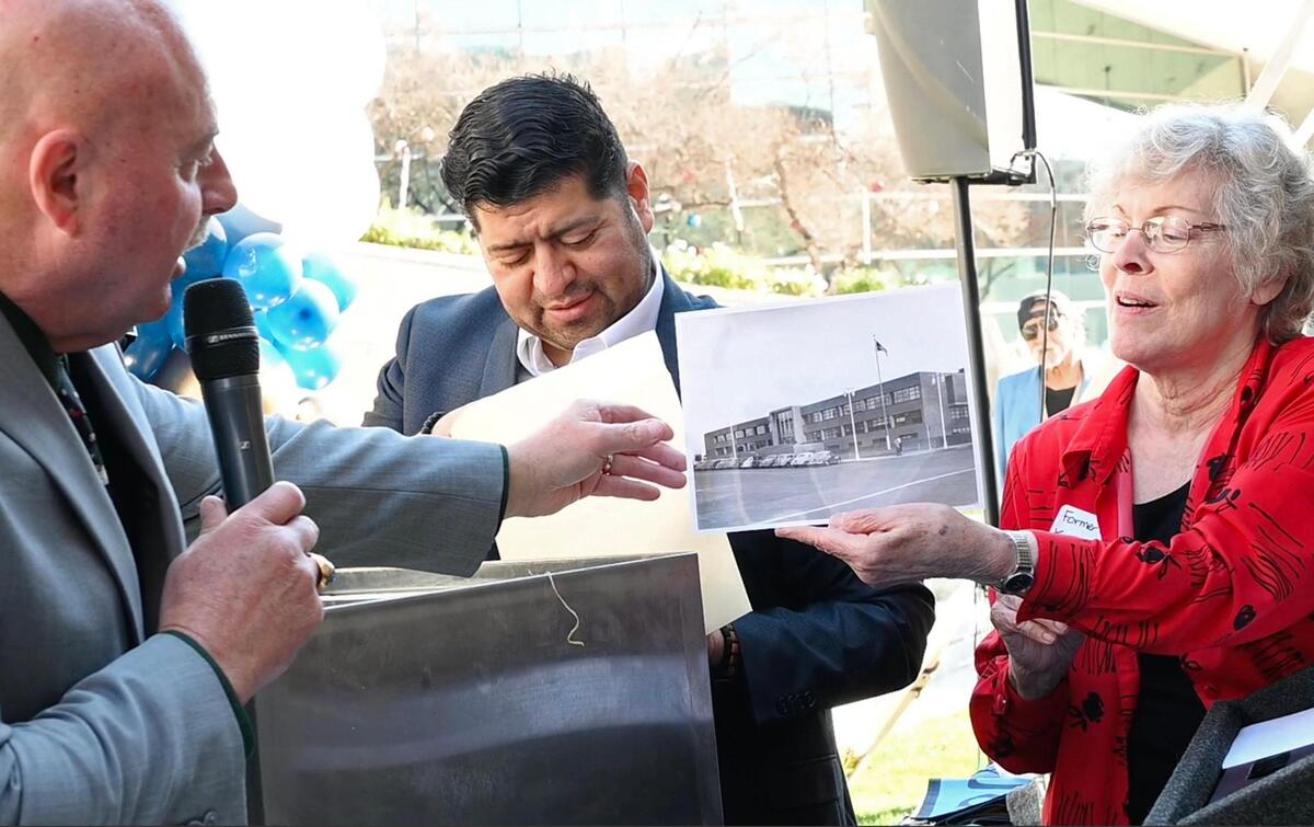 Former Fresno Mayor Karen Humphrey, right, holds up a photo of the former Fresno City Hall, for current Fresno Mayor Jerry Dyer, left, with council member Luis Chavez in the background, one of many items retrieved from a time capsule locked inside a structural part of City Hall during a ceremony in front of City Hall Tuesday, Dec. 13, 2022 in Fresno. The contents had been buried for 30 years. A new time capsule will be locked away and retrieved in another 30 years.