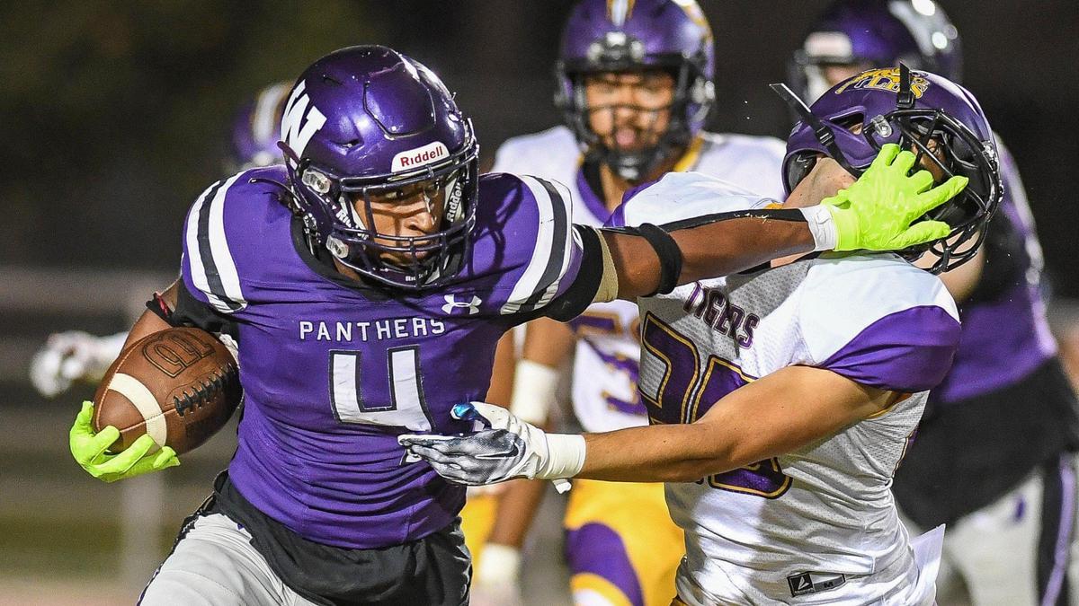 Washington Union’s Joshua Vega, left, stiff-arms Lemoore’s Daniel Rodrigues while trying to find a lane through the secondary in their game at Washington Union on Friday, Aug. 26, 2022.