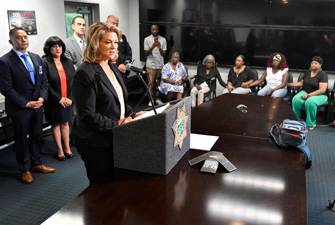 Fresno County District Attorney Lisa SMittcamp, left, helps announce the arrest of a suspect after modern DNA methods led to the arrest in the 1987 cold case murder of Jacqueline Henry, as Henry’s family sits in the background during a press conference Tuesday, July 25, 2023 in Fresno.
