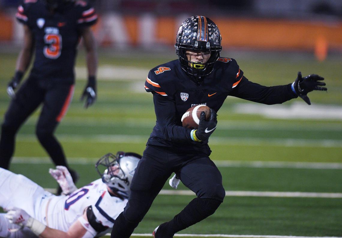 Central’s Jesiah Lindsey fights for yardage against Liberty-Bakersfield in the Central Section DI championship Friday, Nov. 26, 2021 in Fresno. Liberty led 35-7 at halftime,