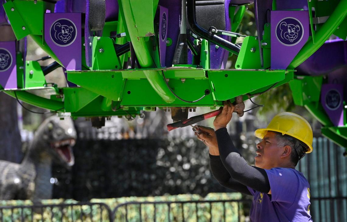 A worker makes adjustments to the Joker’s Remix, a new ride at Playland Fresno in Roeding Park Thursday morning, June 20, 2024 in Fresno.
