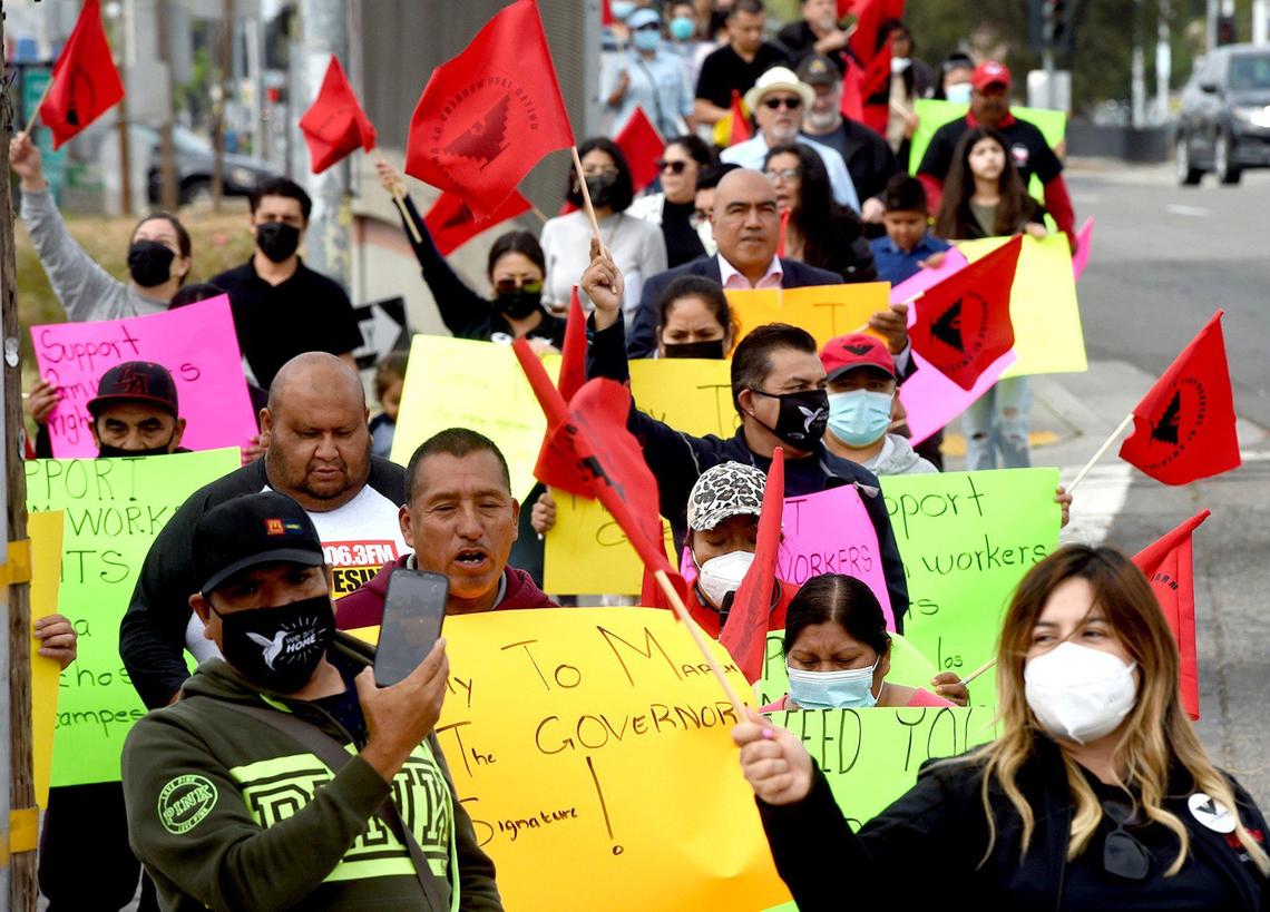 Farmworkers and labor advocates march on Fresno Street, urging Governor Newsom to sign the Ag Labor Voting Choice Act, providing more choices in how farm workers can vote in their union elections, March 31, 2022.