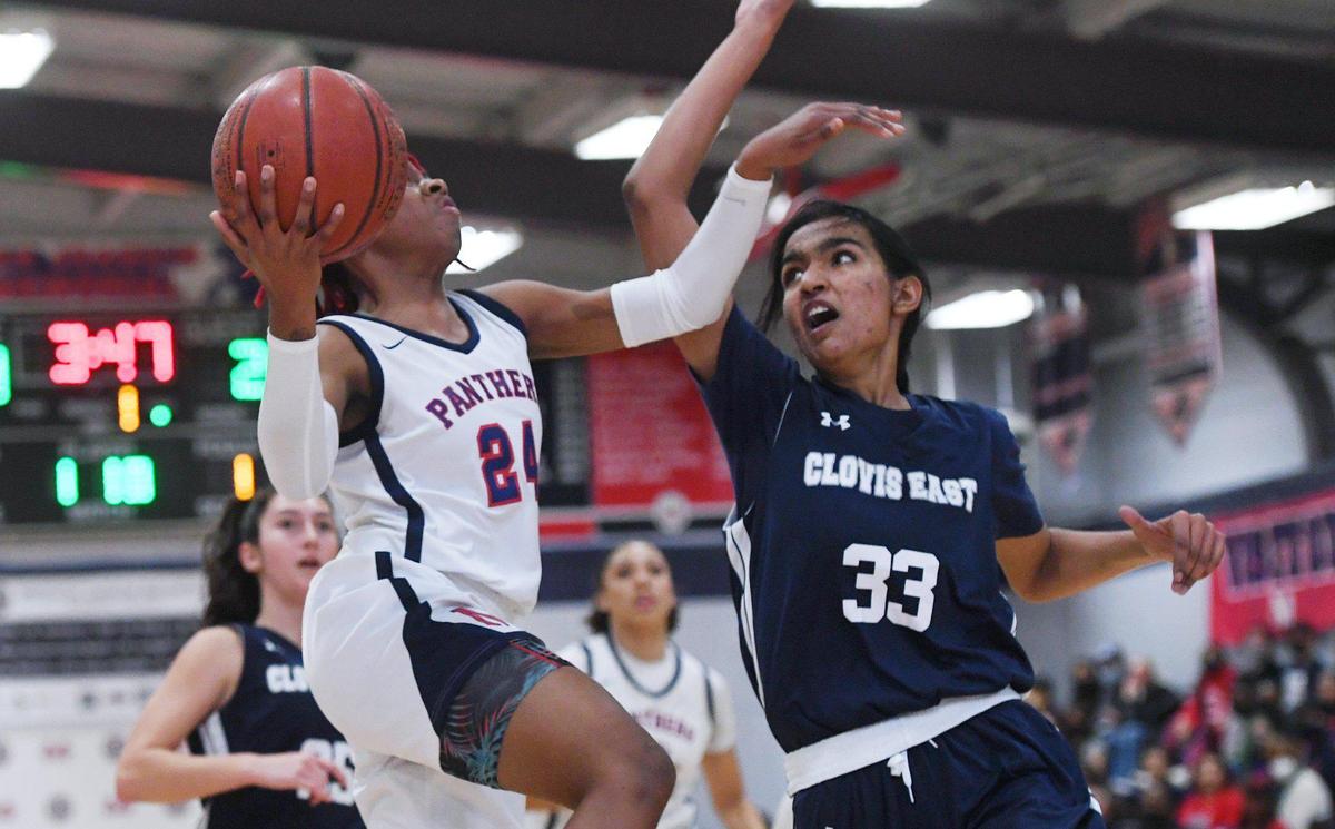 San Joaquin Memorial’s Malaysia Williams, left, goes up with Clovis East’s Rajdeep Kaur to the right Friday, Feb. 18, 2022 in Fresno.