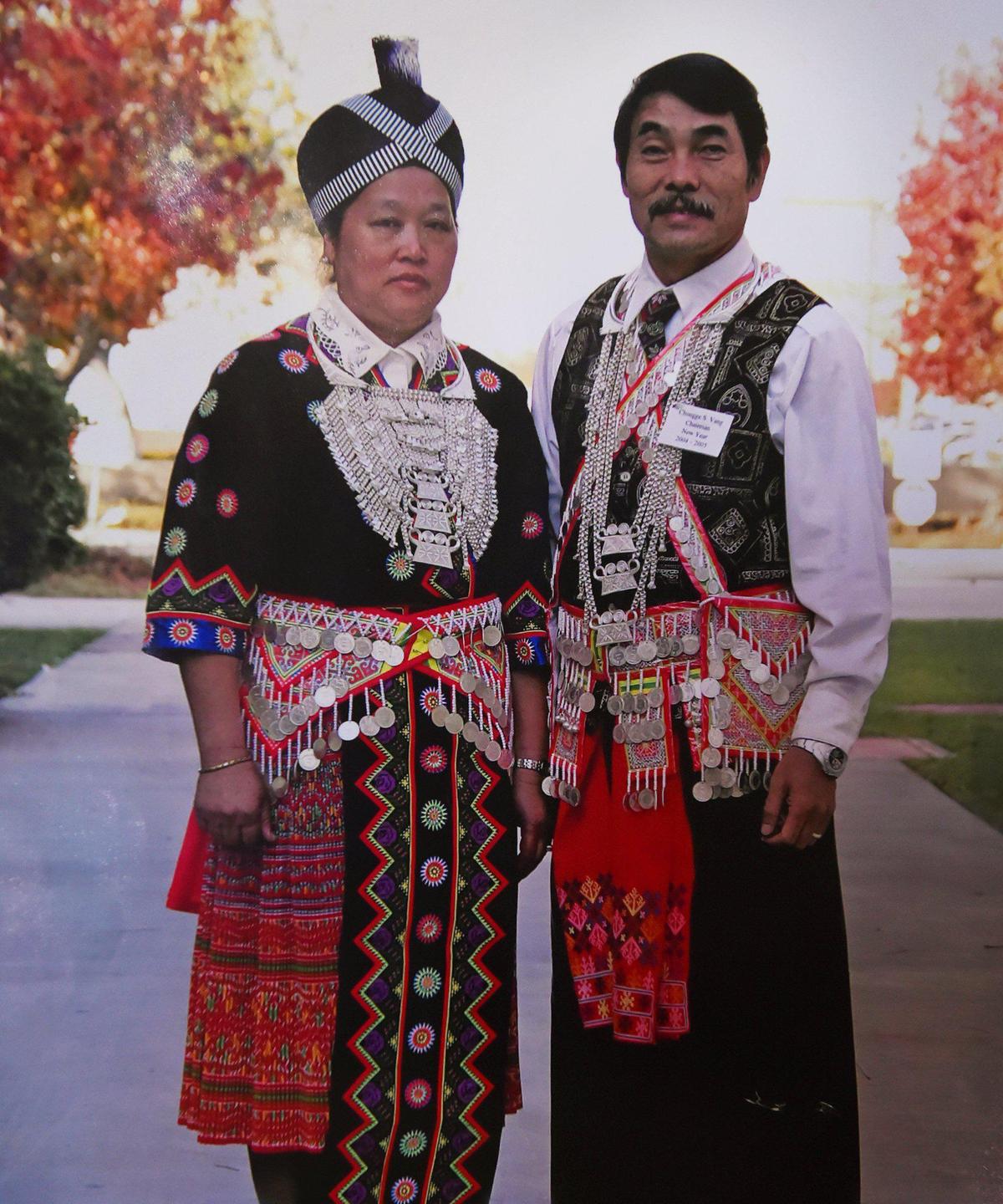 Chongge Vang, 79, right, stands alongside his wife My Her Vang, left, in traditional Hmong clothing, in a family photo Wednesday, July 24, 2019 near Sanger. Vang suffered ongoing depression after losing his friends over the years, which was made worse after his wife died in 2018. The Fresno Center is opening its Living Well Center to focus on mental health issues for its clients.