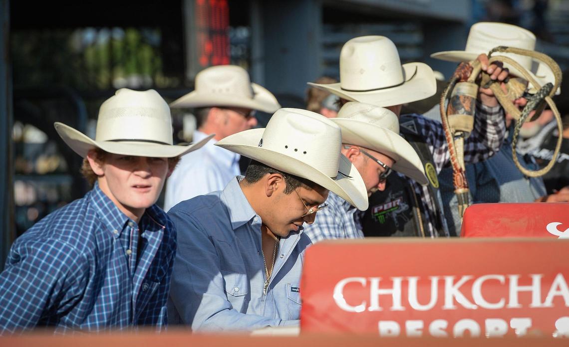 Cowboys get ready at the chutes for the start of the PBR event to start the Clovis Rodeo at the Clovis Rodeo Grounds on Wednesday, April 21, 2021.
