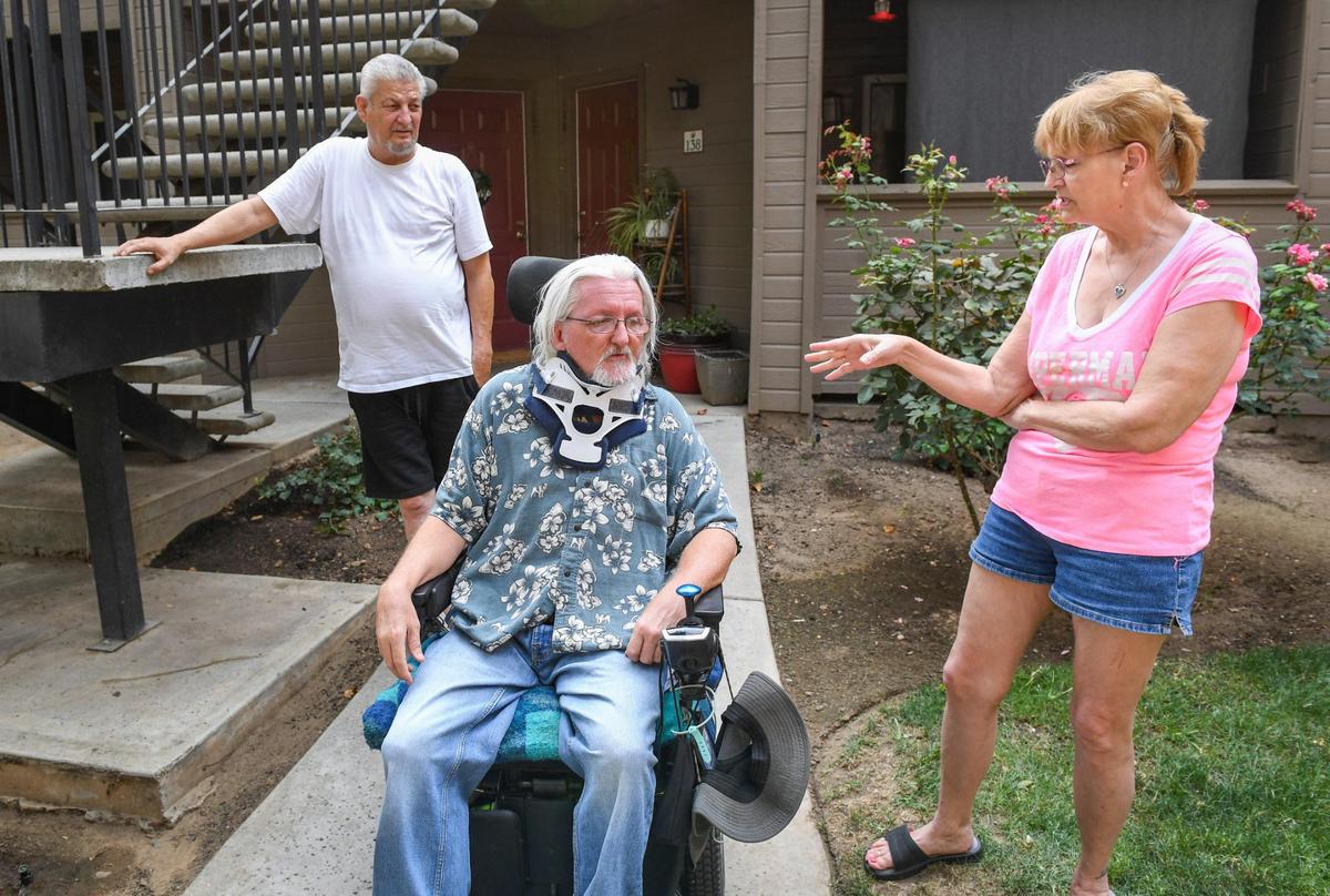 Apartment residents, Eloy Cardenas, from left, James Evans, and Michelle Toler talk about the rent situation at their complex, Sierra Ridge Apartments in Clovis on Monday, Aug. 16, 2021. All three are part of low-income programs that allow them to pay their rent.