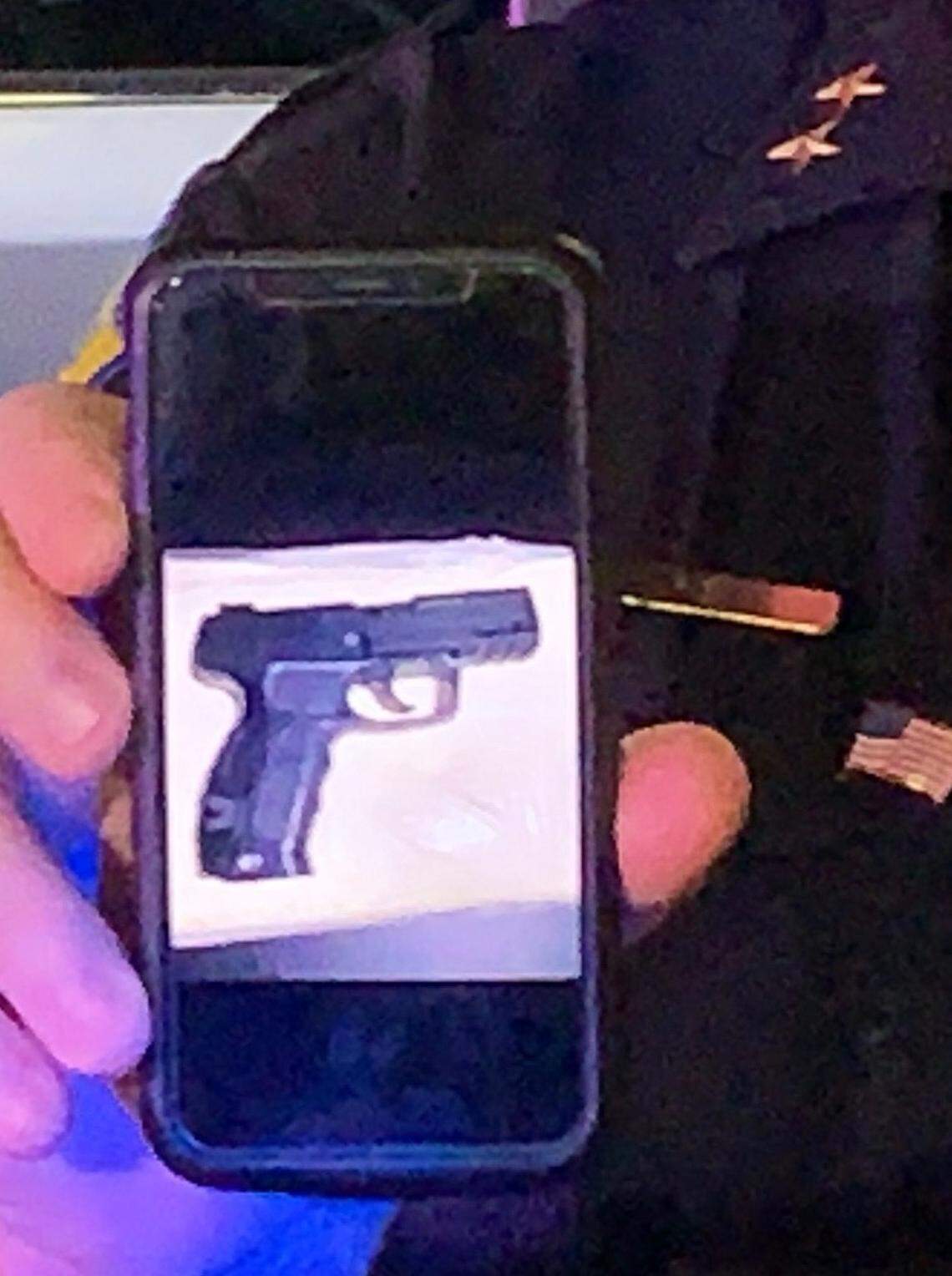Fresno police Deputy Chief Michael Reid shows a photo of the gun a suspect allegedly had when an officer shot and wounded him. The shooting happened around 8 p.m. outside of a southeast Fresno convenience store.