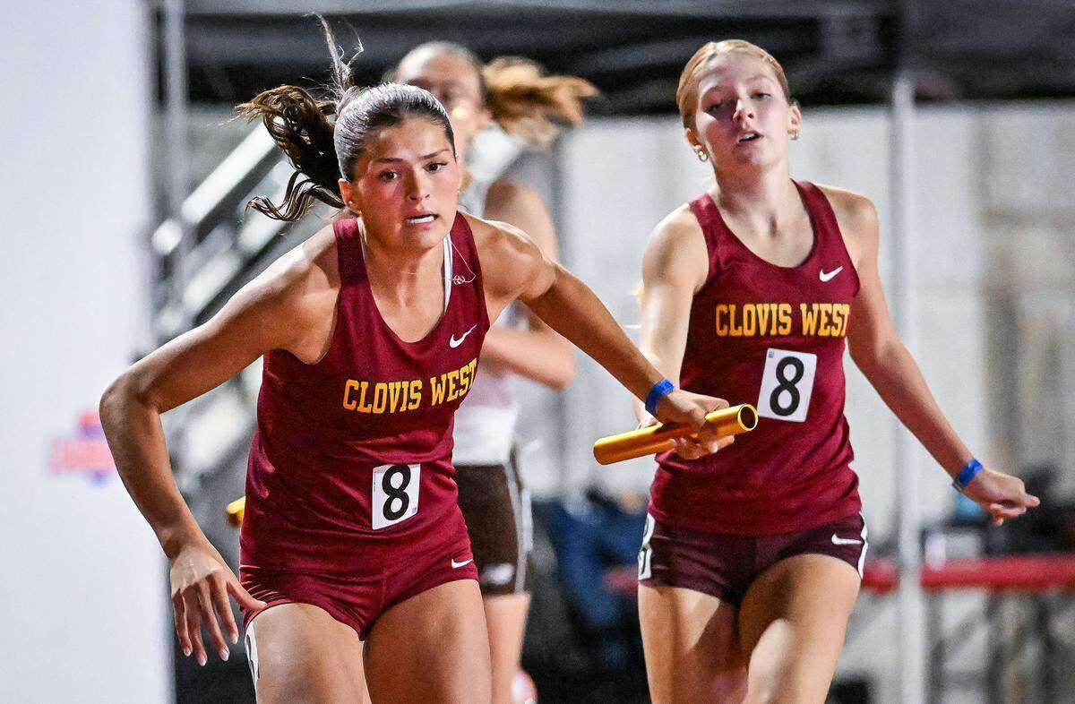 Clovis West's Ryleigh Schoonover, left, takes the baton from teammate Alison Ivy in the girls' 1600 relay during the CIF state track and field championships at Veterans Memorial Stadium in Clovis on Saturday, May 30, 2026.