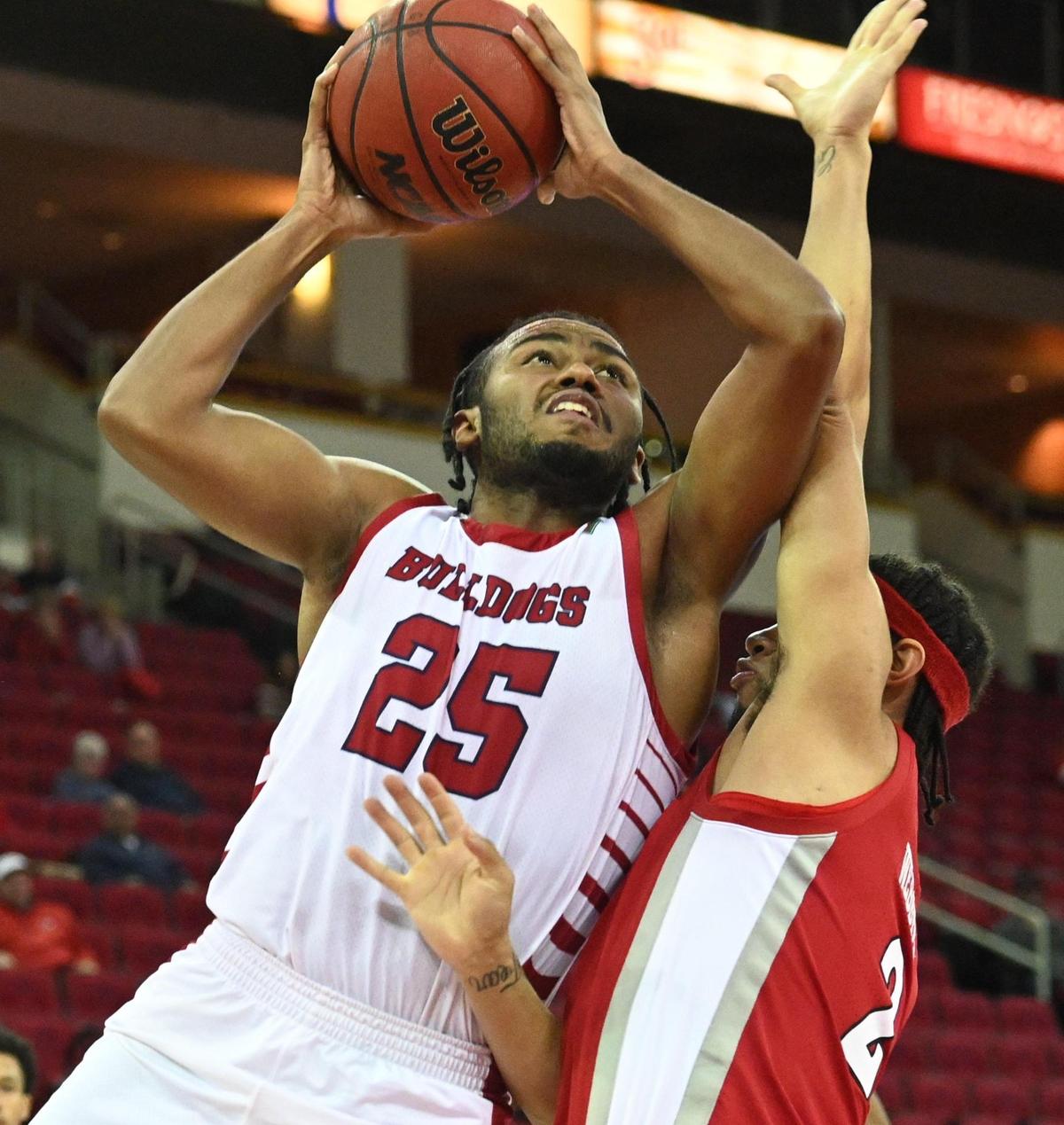 Fresno State’s Anthony Holland, left, goes to the hoop while defended by UNLV’s Justin Webster during their game at the Save Mart Center in Fresno on Wednesday, Feb. 16, 2022.