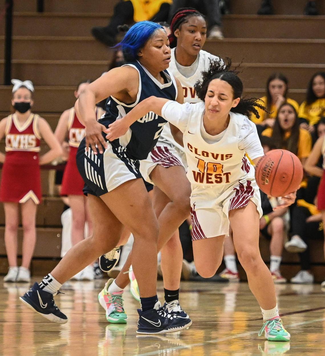 Clovis West’s Trinity Tolbert, right, gets bumped by Bakersfield’s Erica Hayden after stealing the ball during their Central Section Open Division championship game at Clovis West on Saturday, Feb. 26, 2022.