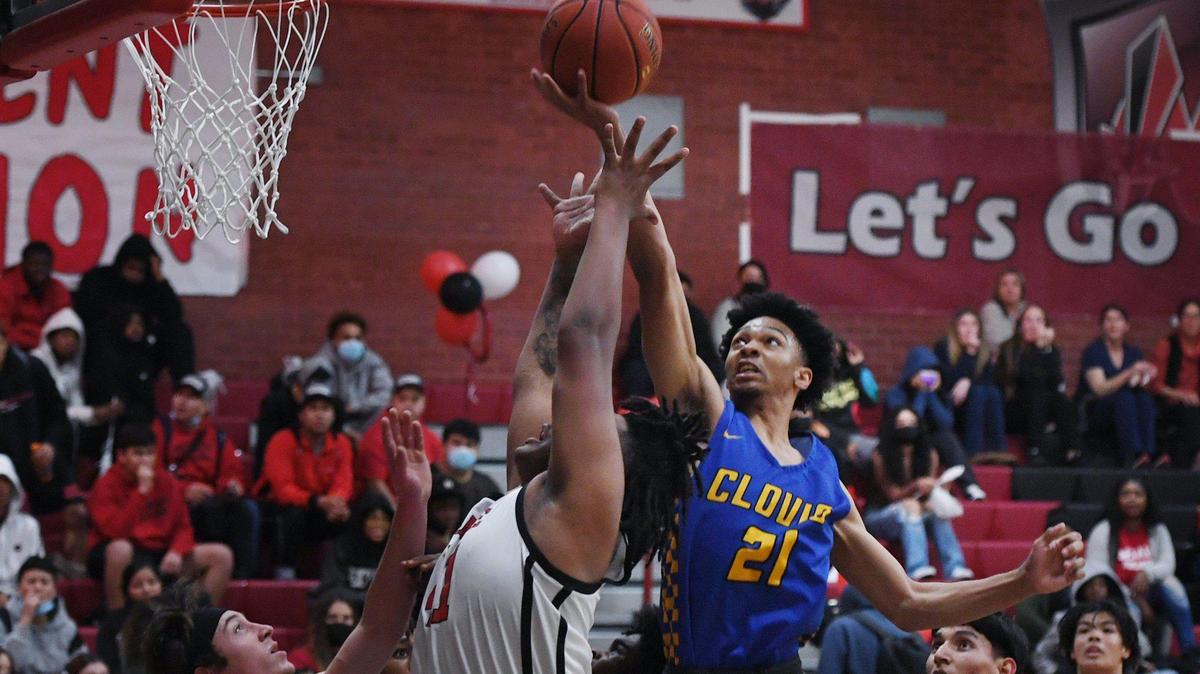 Clovis’ Treyvonn Sanderson goes for the ball during a Central Section boys basketball playoffs game on Tuesday, Feb. 15, 2022.