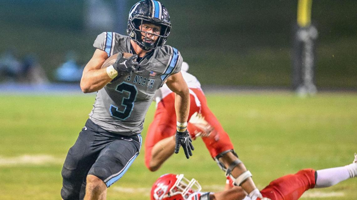 Clovis North’s Mckay Madsen runs past Sanger defenders on his way to a long touchdown run in the second quarter of their Division I-AA quarterfinal playoff game at Veterans Memorial Stadium in Clovis on Friday, Nov. 8, 2024.