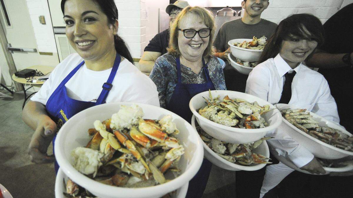 Los Banos Rotary Club members Kimberly Chatman, left, and Pat Selinger are joined with high school Interact Club members as they prepare to serve crab during the annual Rotary Crab Feed held at the Los Banos Fairgrounds. Proceeds from the event go toward local high school scholarship.
