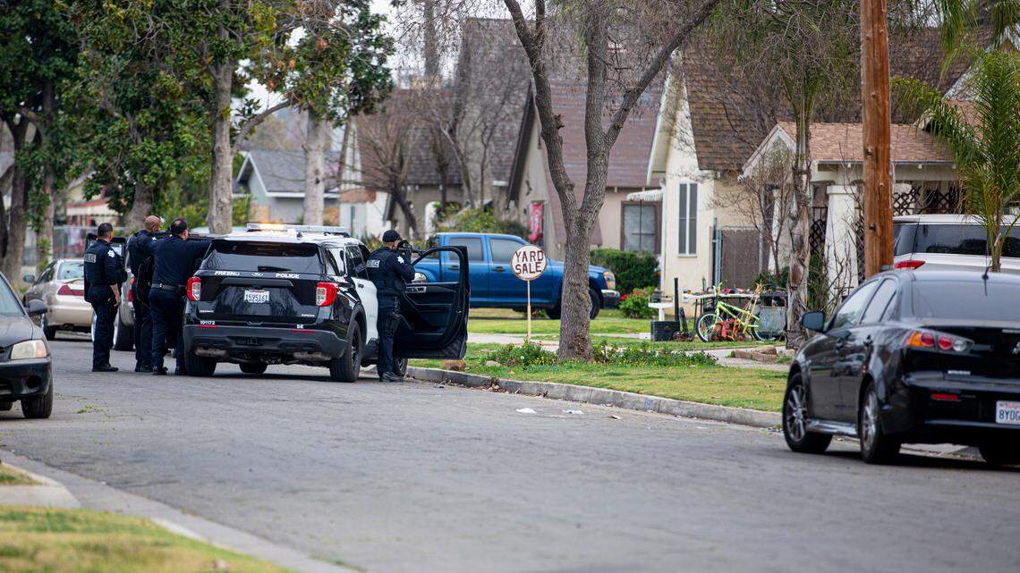 Police block off the street to search a home for a possible suspect after a shooting Sunday, Feb, 20, 2022, in a southeast Fresno neighborhood.